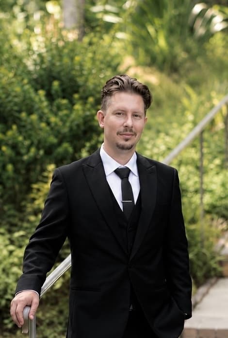 Alan Uzunyan wearing a black suit